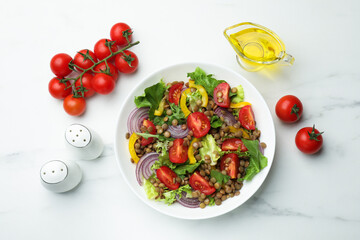 Delicious salad with lentils and vegetables served on white marble table, flat lay