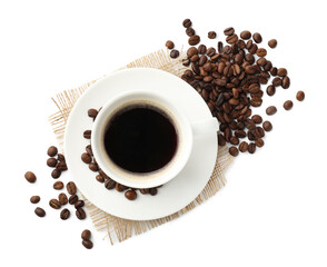 Cup of aromatic coffee and roasted beans isolated on white, top view