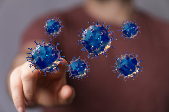An image depicting a person's hand interacting with virus particles. Concept of disease, science, and the figh