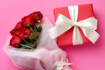 Saint Valentine's day. Beautiful gift and roses on pink background, flat lay