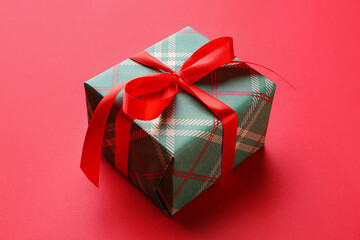 Beautiful gift box on red background, closeup