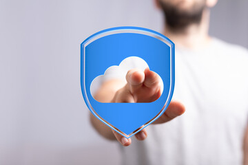 Hand touching cloud computing security with shield. Protect your data and digital information. Cloud computing