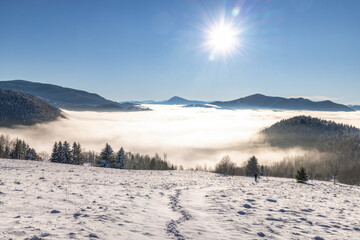 Snowy winter landscape in a misty sunny morning. The Orava region in north of Slovakia, Europe.