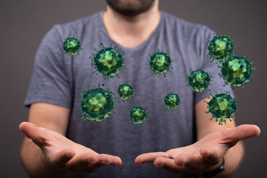 Image of a man holding stylized viruses, symbolizing health, disease, and the COVID-19 pandemic. A concept rep
