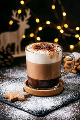 Layered hot chocolate or latte with foam, served with gingerbread and festive lights
