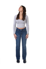 Naklejka premium front view portrait of an 18-year-old girl standing, looking up and looking side on white background