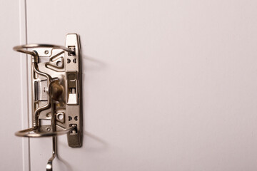 A detailed shot of a metallic binder mechanism against a white background with ample copy space for...
