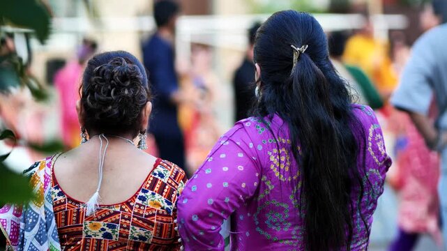 Indian women observing Ganesha festival celebration wearing colorful traditional dress