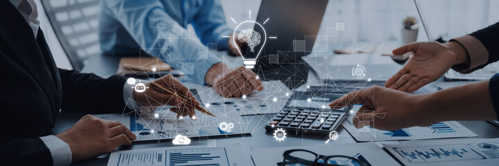 A business team engages in a creative brainstorming session in a modern office, utilizing technology graphics to explore innovative solutions and strategies. Trope