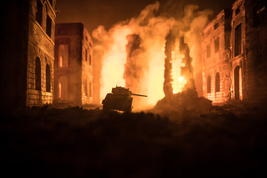 War Concept. Military silhouettes fighting scene on war fog sky background, World War Soldiers Silhouette Below Cloudy Skyline At night. Battle in ruined city.