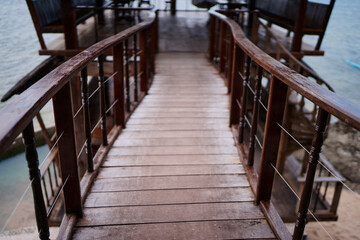 Wooden Pathway Leading to a Waterfront Structure with Scenic Views