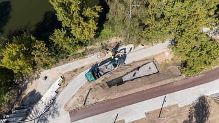 Aerial View of Construction Site with Machinery and Workers