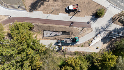Aerial View of Construction Site with Trucks and Workers