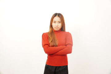 Annoyed young woman standing with arms crossed and a serious or disapproving expression on her face.