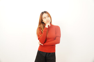 Pensive young woman thinking deeply with her hand on her chin, looking up for inspiration, ideas, or to find a solution