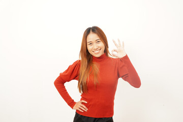 Cheerful young woman smiling widely while making the 'OK' hand gesture, indicating approval, satisfaction, or a perfect result.