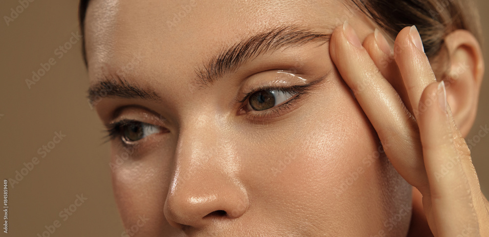Eye close-up with perfect brows (Adobe Stock comp)