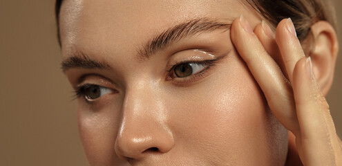 Close-up of female eye with glossy eyeliner and perfect skin texture