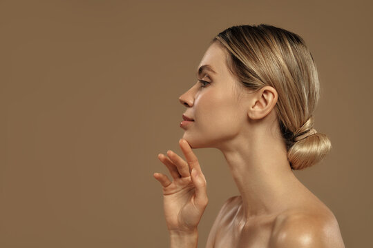 Side profile of elegant young woman with glowing skin