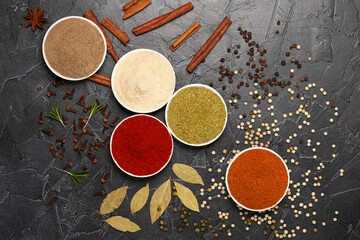 Spices turmeric, paprika, cardamom, nutmeg, black pepper and allspice.