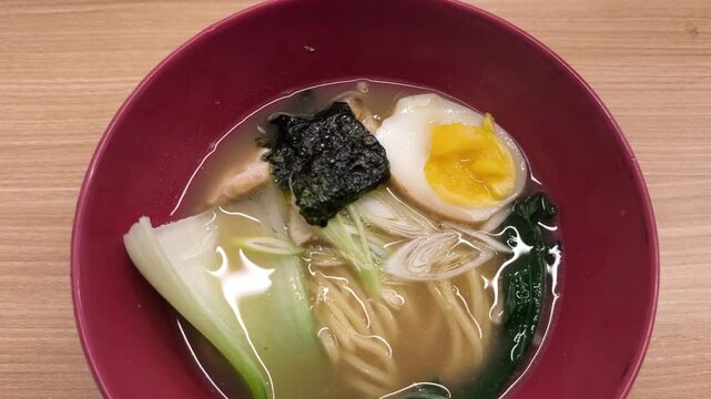 Japanese ramen soup with egg seaweed bok choy noodles broth