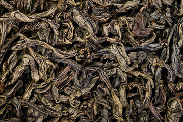 Detailed macro of loose dried tea leaves. Wrinkled texture, earthy colors, natural organic...