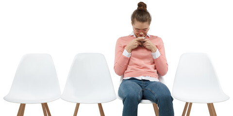 Young geek female student looking at her phone and texting with friend
