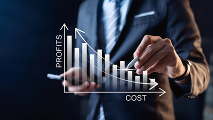 Businessman analyzing profits and cost graph with increasing profits