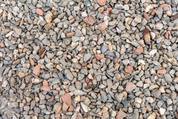 Close-up of fine gravel and crushed stone as a textured stone background of natural origin
