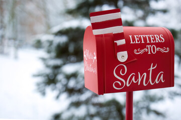 Santa's Mailbox in Snowy Scene. Red mailbox for letters to Santa, set in a snowy winter background
