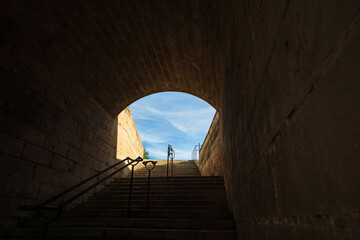 Historic courtyard with stone arches and soft lighting inside a traditional building. Elegant Mediterranean architecture.
