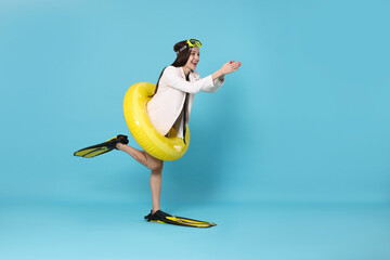 Businesswoman with diving mask, air mattress and flippers on light blue background, space for text © New Africa