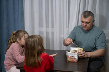 Family enjoys dessert together in a cozy kitchen during evening hours while sharing smiles and laughter