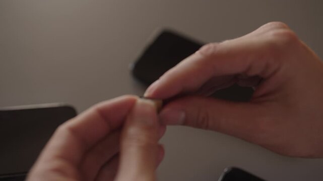 Male hands holding nano sim card, preparing to insert into tray for new smartphone, transferring data and mobile service from old device. Concept of telecom, repair, device management, close-up.