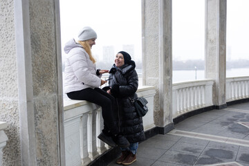 Meeting two friends, chatting and walking in the park