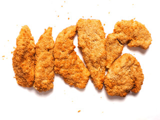 Uncooked chicken goujons or tenders in on white background. Popular classic chicken dish made from pieces of breast and breadcrumbs. Traditional ready to cook poultry product.