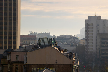 Close up view of residential and office towers framing old roof