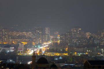 Fototapeta premium Night cityscape with Ar-Rahma Mosque and traffic