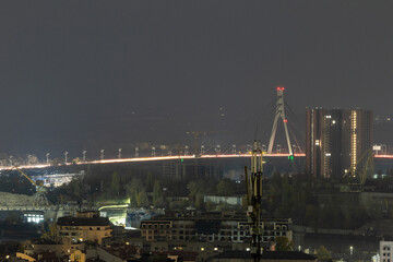 Fototapeta premium Illuminated Northern Bridge and night city traffic