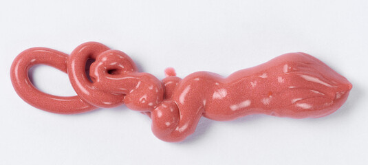 Squeezed red liquid lipstick with glitter on white background, top view