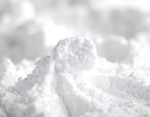 A close-up shot of a white, fine powdery substance with a soft texture and small clumps.