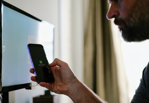 Middle Aged Man Working From Home Remotely is Prompted for Multi Factor Authentication Approval While Signing In Work Computer Cybersecurity Concept - Powered by Adobe