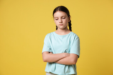 Portrait of cute girl on yellow background