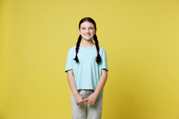 Portrait of cute girl on yellow background