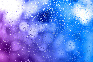 Fototapeta premium Glass window surface with water drops, closeup view