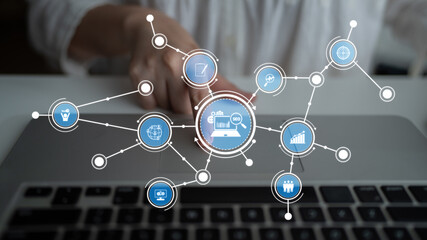 A creative representation of data visualization showcasing interconnected icons that symbolize business insights and technological interaction on a laptop in a modern workspace. Tessel