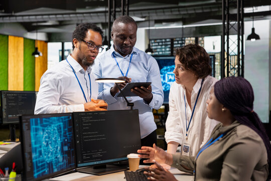 Admins doing brainstorming in office, automating repetitive tasks using AI on PC. Startup coworkers discuss during meeting about artificial intelligence tech usage to speed up feature implementation