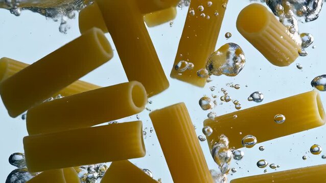 Vibrant Pasta Shapes Splashing in Clear Water