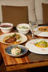 An Array of Assorted Gourmet Dishes Beautifully Arranged on a Charming Wooden Table Setting