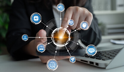 A business professional engages with digital network icons on a laptop, illustrating the essence of technology and innovation in a modern office setting. Crux
